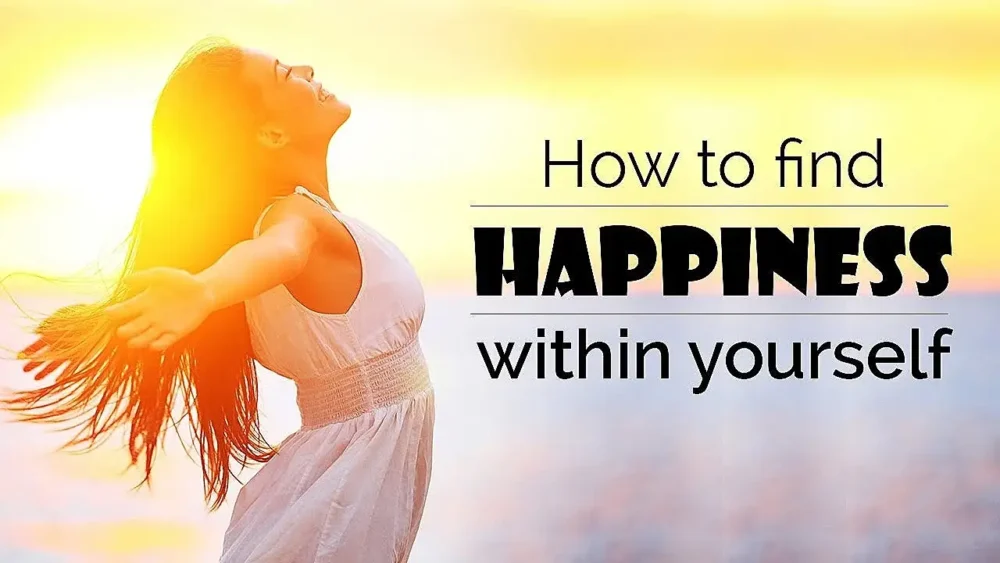 Woman with her arms spread open with wind blowing her hair asking How to Find Happiness Within Yourself.