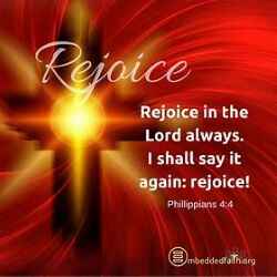 Bright white light in middle of a Cross signifying Jesus Christ on red background with white letters stating Rejoice in the Lord Always.