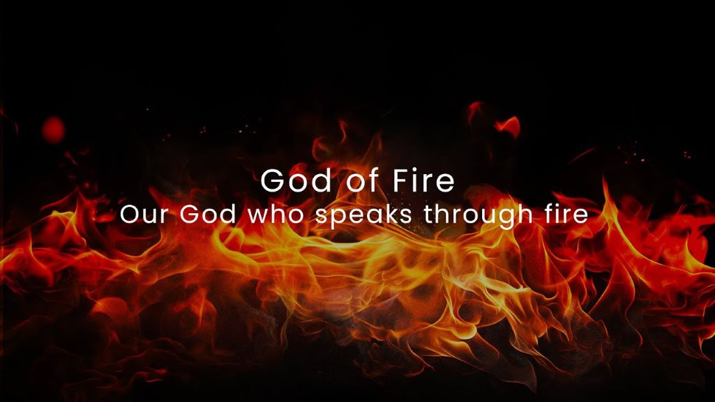God of Fire text overlay on flames. Our God who speaks through fire.