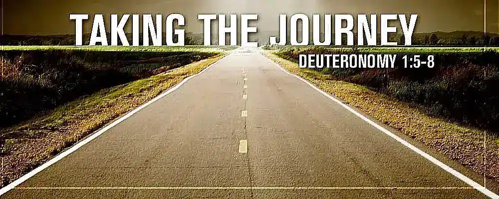 A picture of a road with the words taking the journey on it