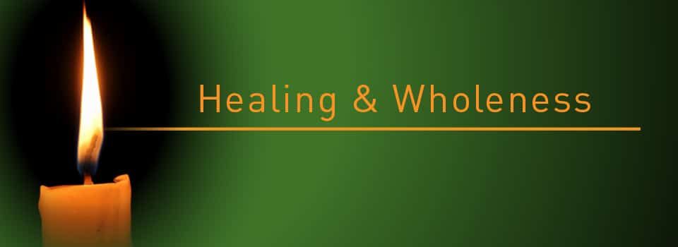 Burning candle on dark background; text: Healing & Wholeness