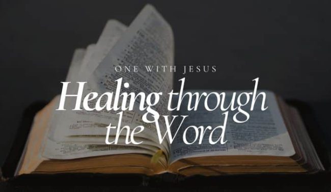 An open Bible with pages fanned out, displaying the text "Healing through the Word" and "ONE WITH JESUS" in white lettering against a dark, moody background, suggesting spiritual comfort and guidance.